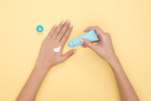 a person applying cream on the hand